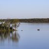 Pomona Lake in Osage County, Kansas, with a fishing boat near a wooded shoreline