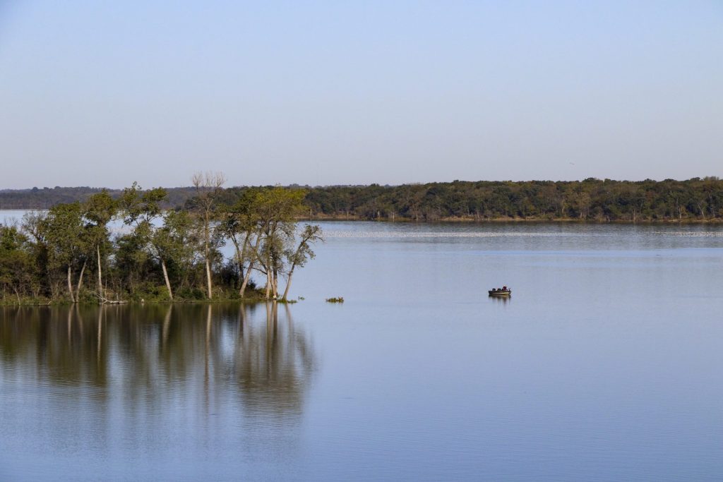 Pomona Lake in Osage County, Kansas, with a fishing boat near a wooded shoreline