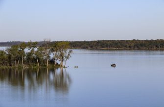 Pomona Lake in Osage County, Kansas, with a fishing boat near a wooded shoreline
